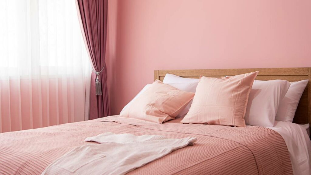 a pink-themed bedroom from the walls to beddings