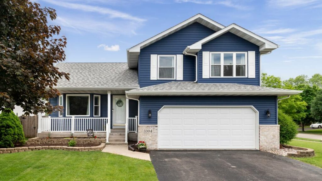a mignight blue suburban home with white garage door
