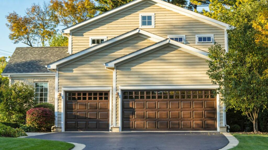 a traditional house with brown garage door