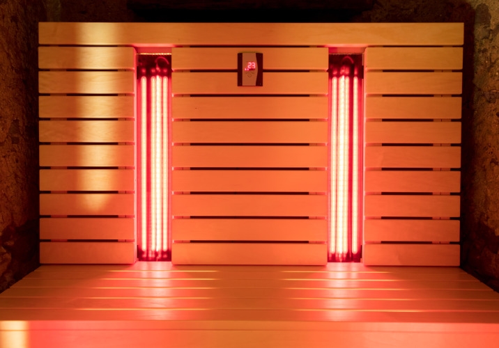 A sauna with two panels of infrared lights to generate heat