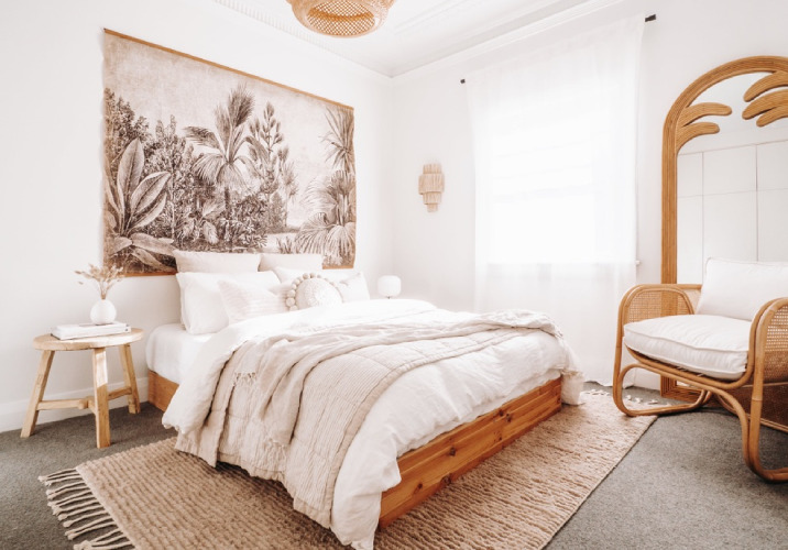 A stylish, carpeted bedroom with a textured rug 