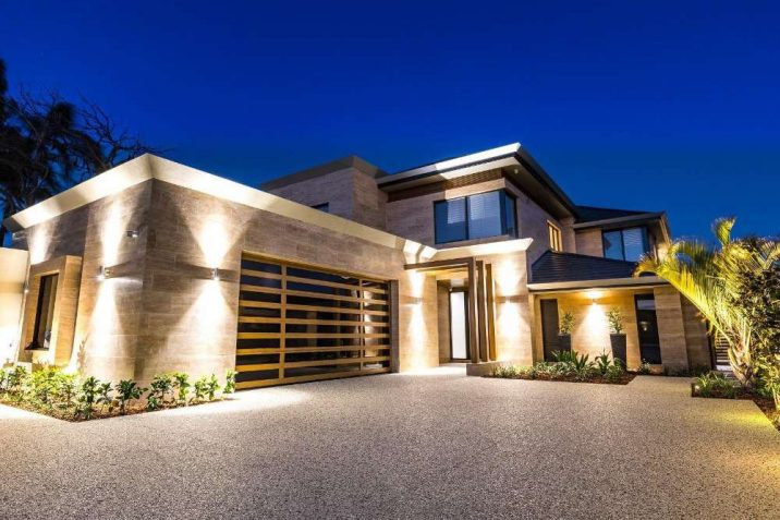 Picturesque two-storey home with polished concrete driveway and travertine walls.