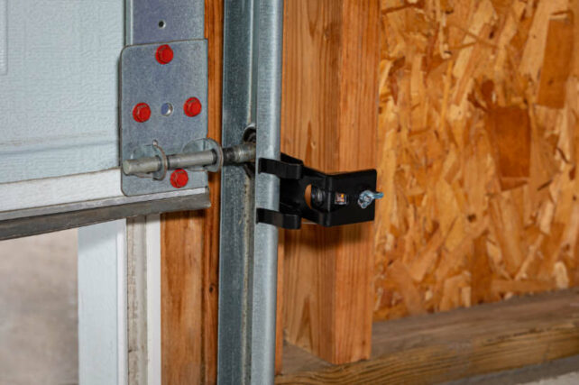 How to fix garage roller door - Garage door track with signs of possible off-track issue.