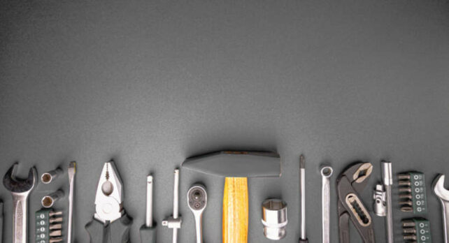 How to fix garage roller door - Set of hand tools arranged on black background