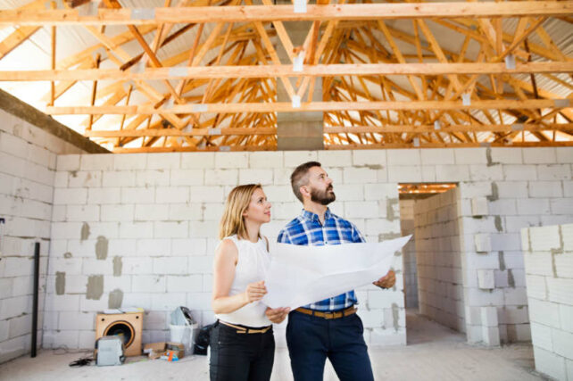 Australian framing standards - Homeowners inspecting construction progress inside a new home.