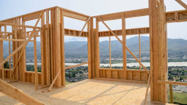 Australian framing standards - Wooden platform framing structure in progress with a mountain and river view.